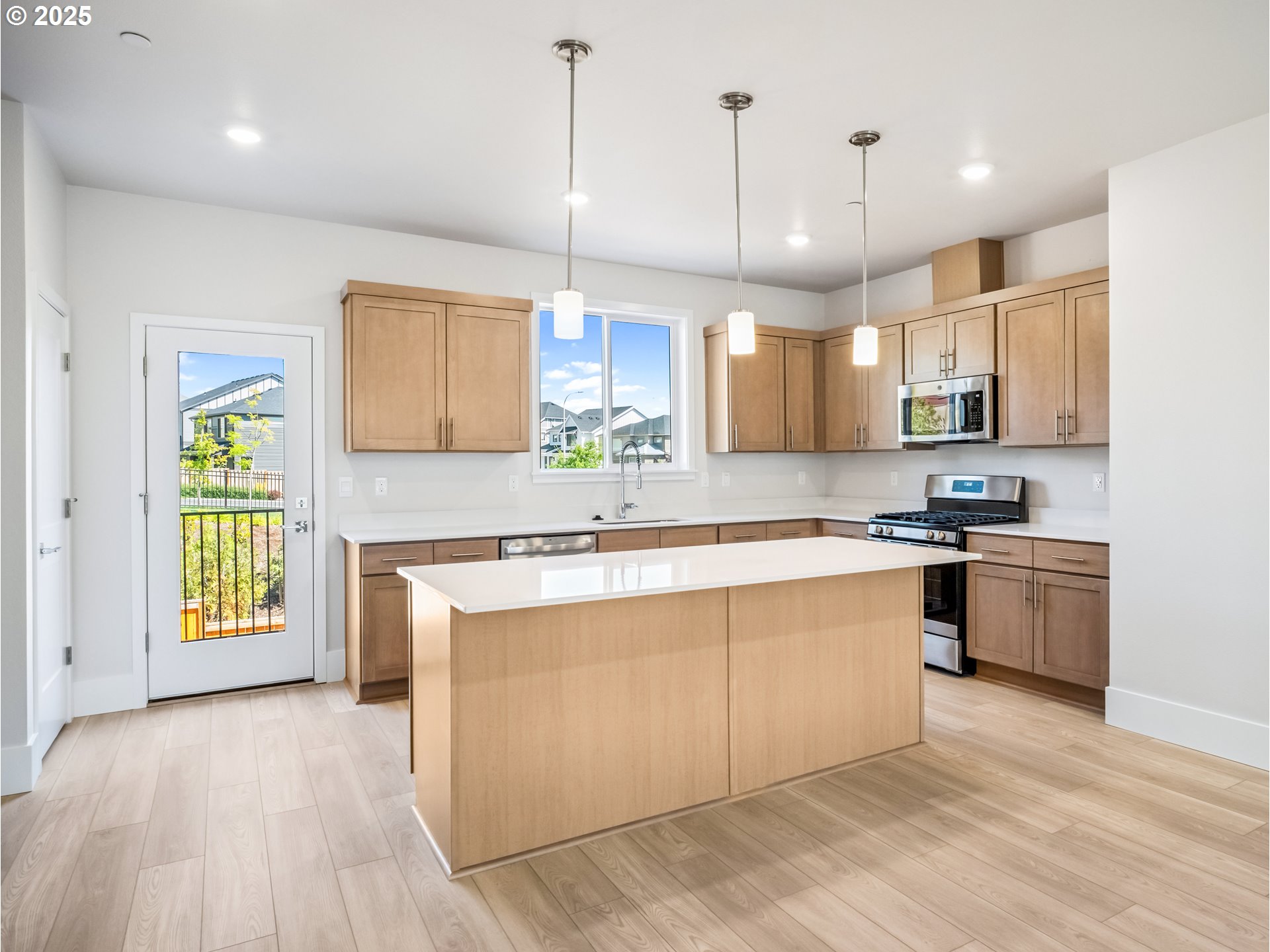 11950 Southwest 176th Drive Beaverton, OR 97007 - Photo 2 of 20 a large kitchen with stainless steel appliances granite countertop a stove a sink a center island a window and a kitchen island