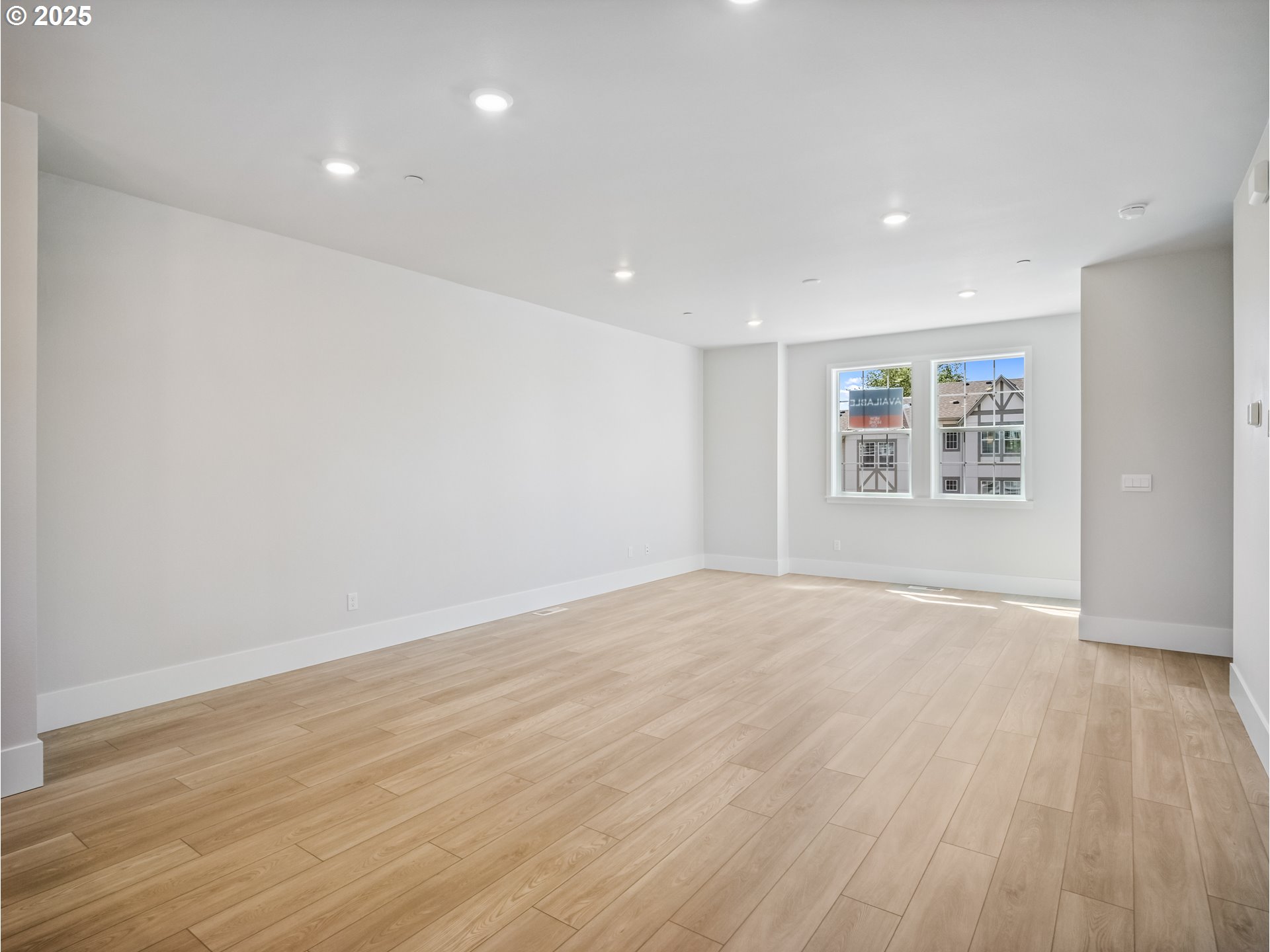 11950 Southwest 176th Drive Beaverton, OR 97007 - Photo 3 of 20 a view of an empty room with a window and wooden floor
