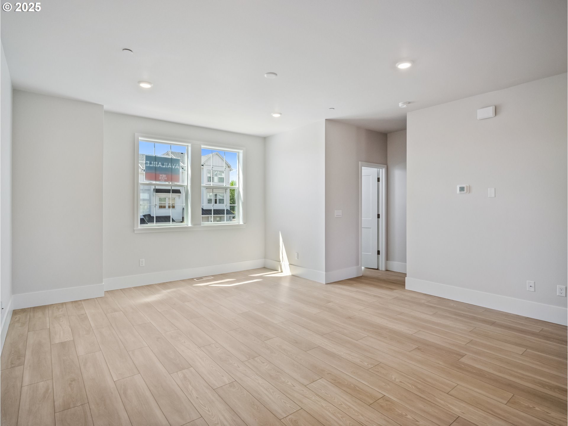 11950 Southwest 176th Drive Beaverton, OR 97007 - Photo 4 of 20 a view of an empty room with wooden floor and a window