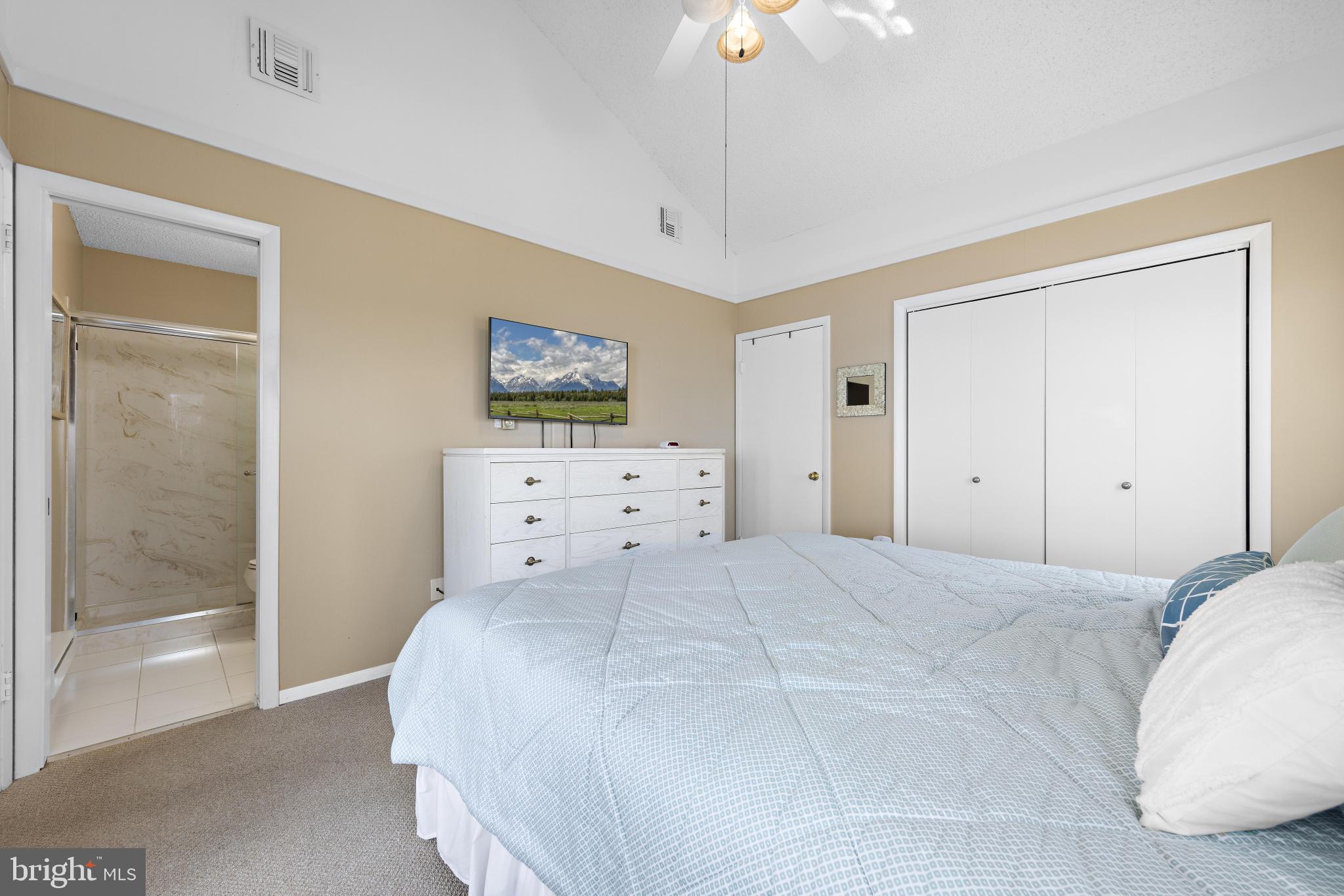24 Joan Road Long Beach Township, NJ 08008 - Photo 19 of 55 a bedroom with a bed and a flat screen tv