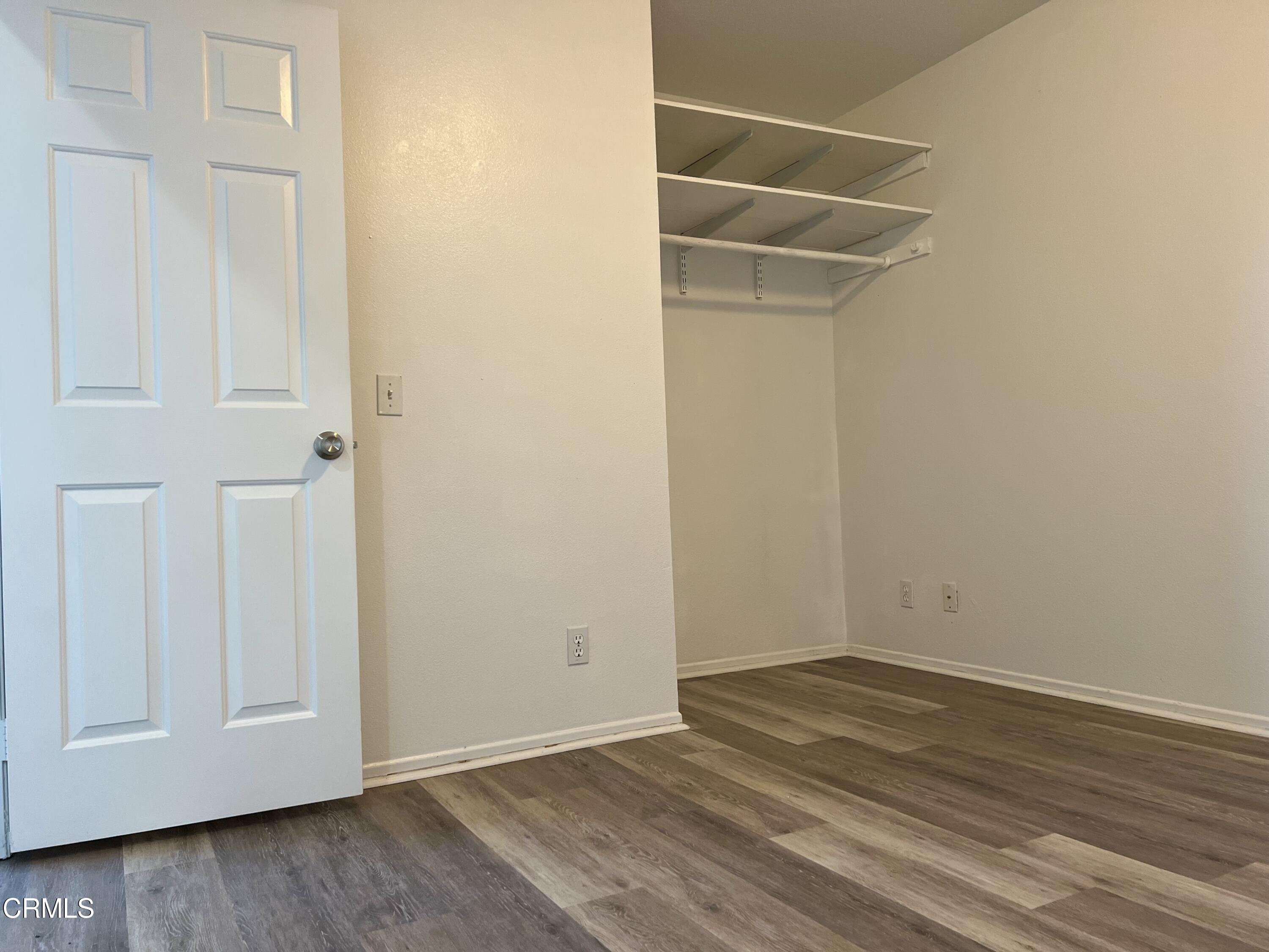 44762 Shadowcrest Drive Lancaster, CA 93536 - Photo 4 of 31 an empty room with wooden floor and closet area