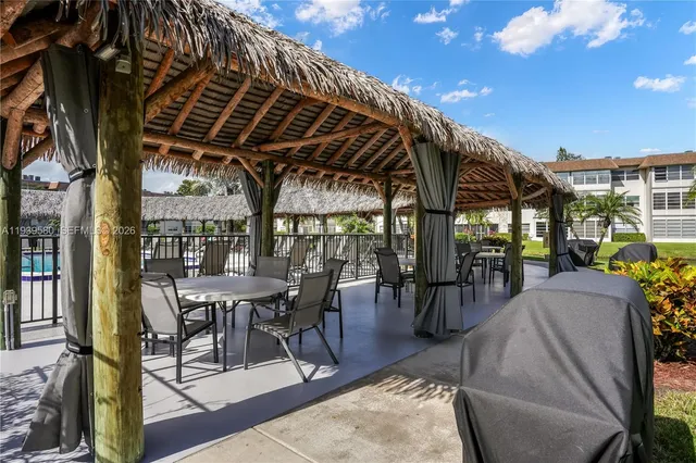 a swimming pool with outdoor seating and yard