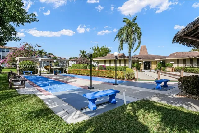 a view of a house with swimming pool and sitting area