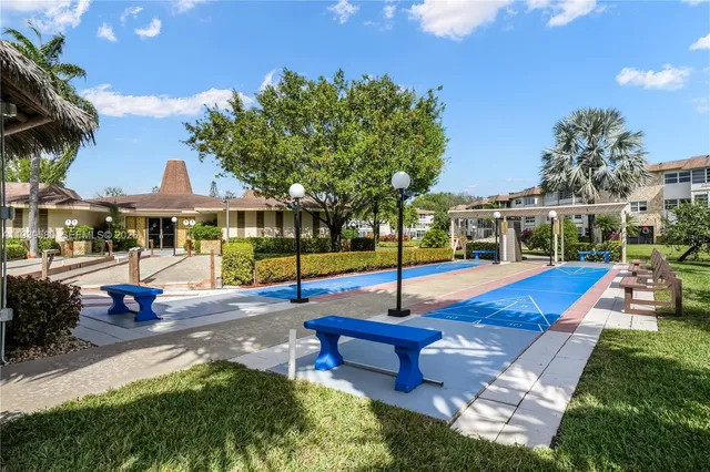 a view of a patio with swimming pool table and chairs