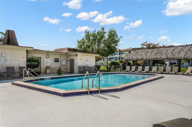 a view of swimming pool with outdoor seating and yard