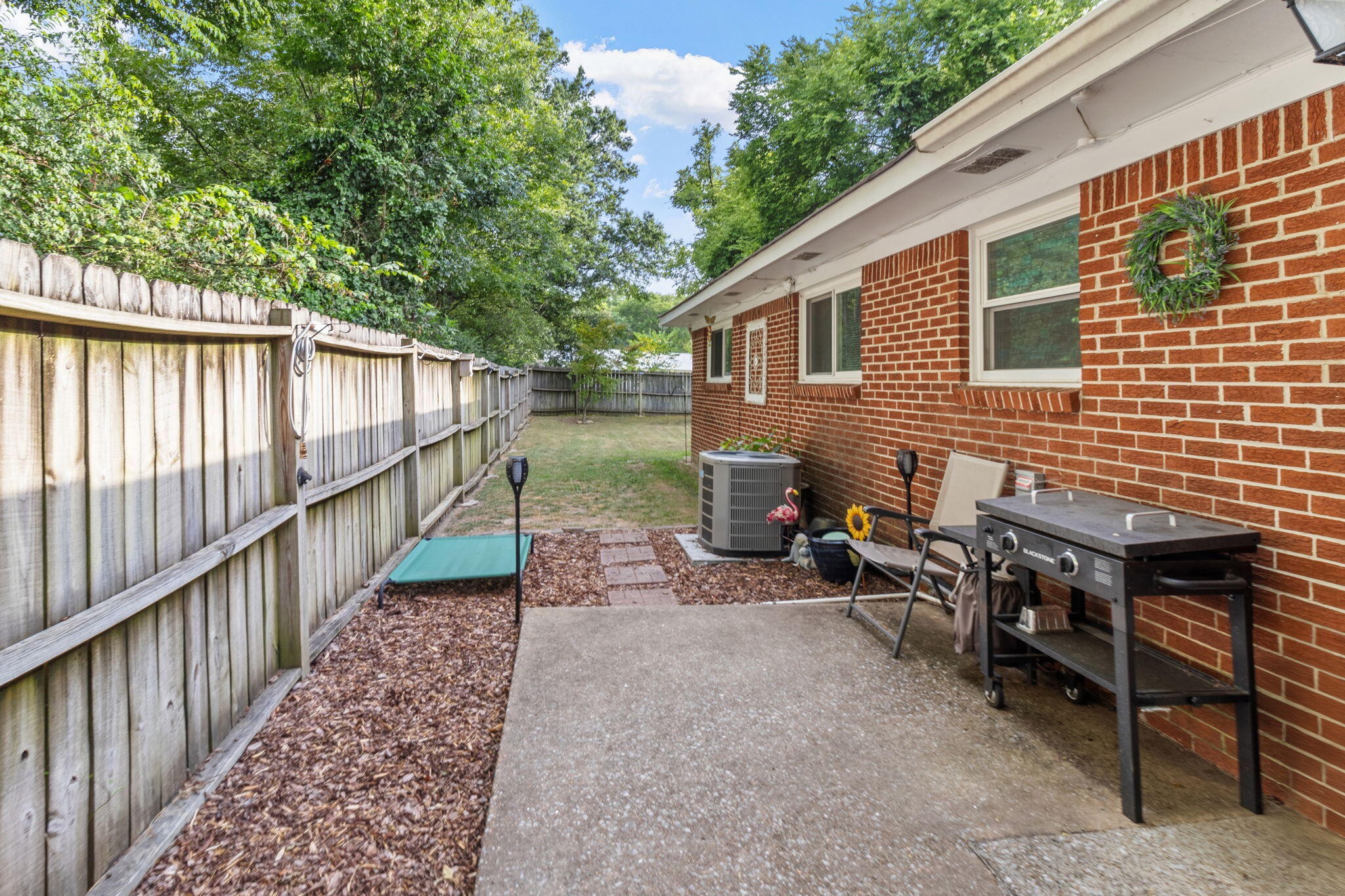 4222 Ealy Road Chattanooga, TN 37412 - Photo 23 of 26 a view of a patio with table and chairs and wooden fence