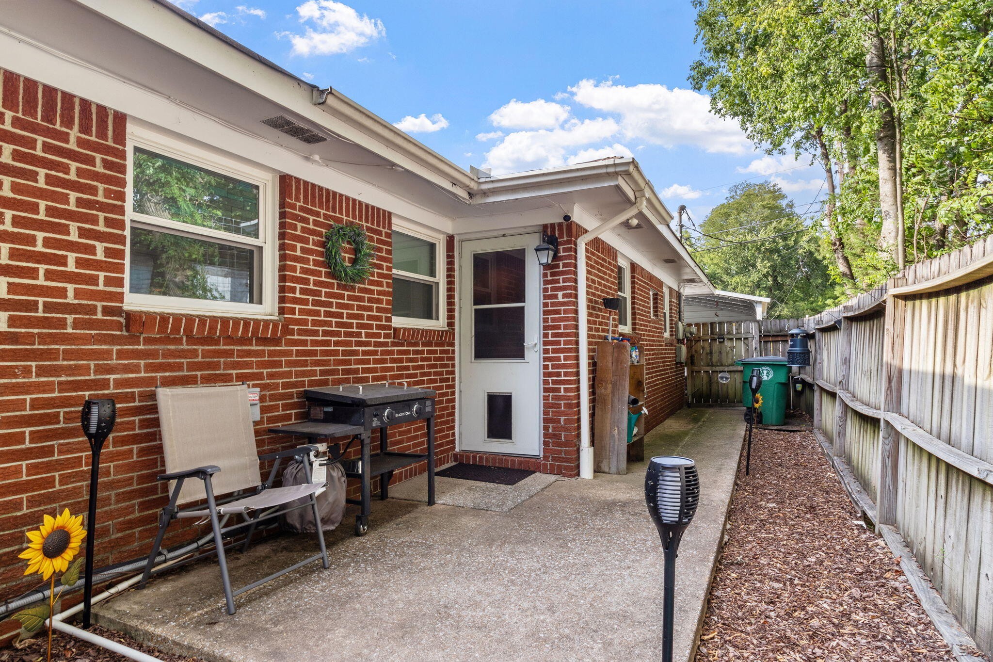 4222 Ealy Road Chattanooga, TN 37412 - Photo 24 of 26 a view of a patio with table and chairs with wooden fence and floor