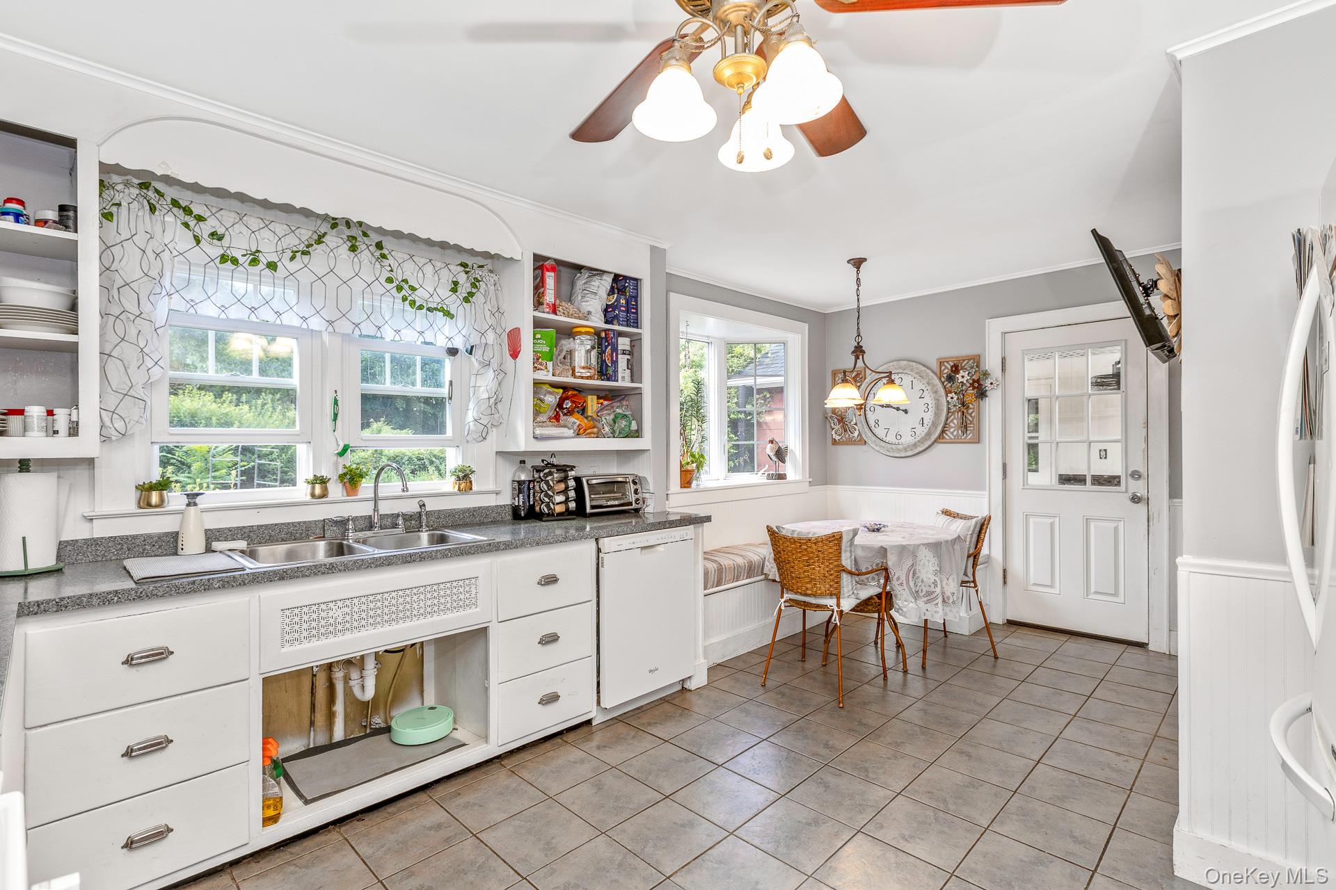 5660 Sound Avenue Mattituck, NY 11952 - Photo 14 of 43 Kitchen featuring open shelves, a wainscoted wall, white cabinetry, white dishwasher, and ceiling fan