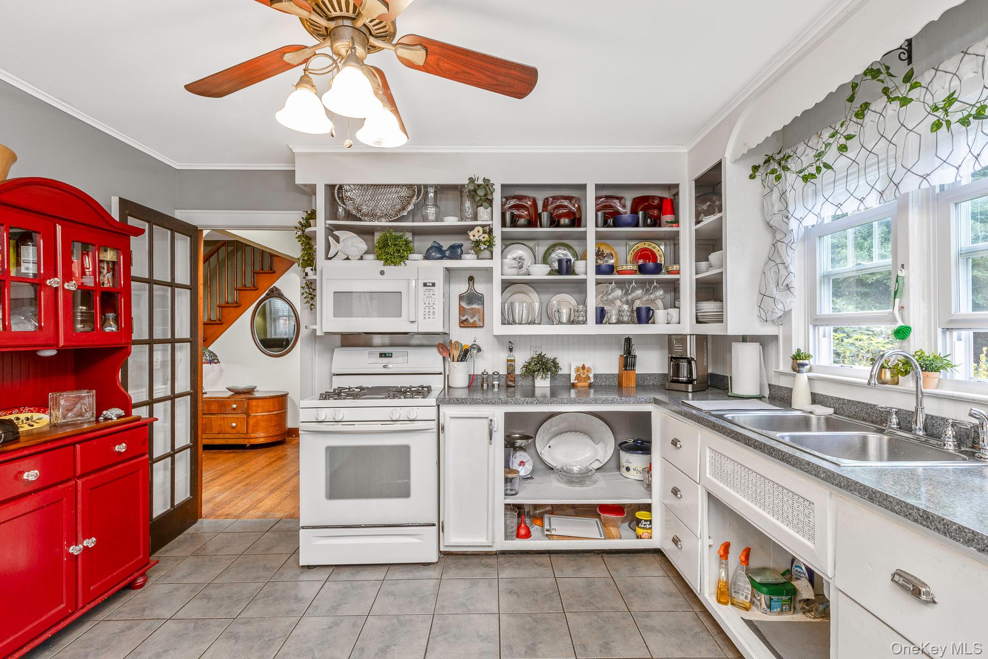 5660 Sound Avenue Mattituck, NY 11952 - Photo 17 of 43 Kitchen featuring open shelves, white appliances, crown molding, light tile patterned floors, and white cabinets