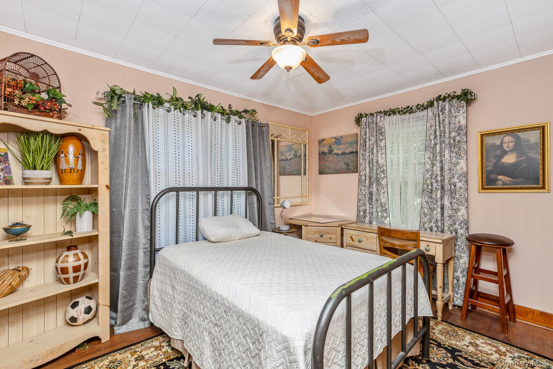 5660 Sound Avenue Mattituck, NY 11952 - Photo 22 of 43 Bedroom with ornamental molding, wood walls, wood finished floors, and a ceiling fan