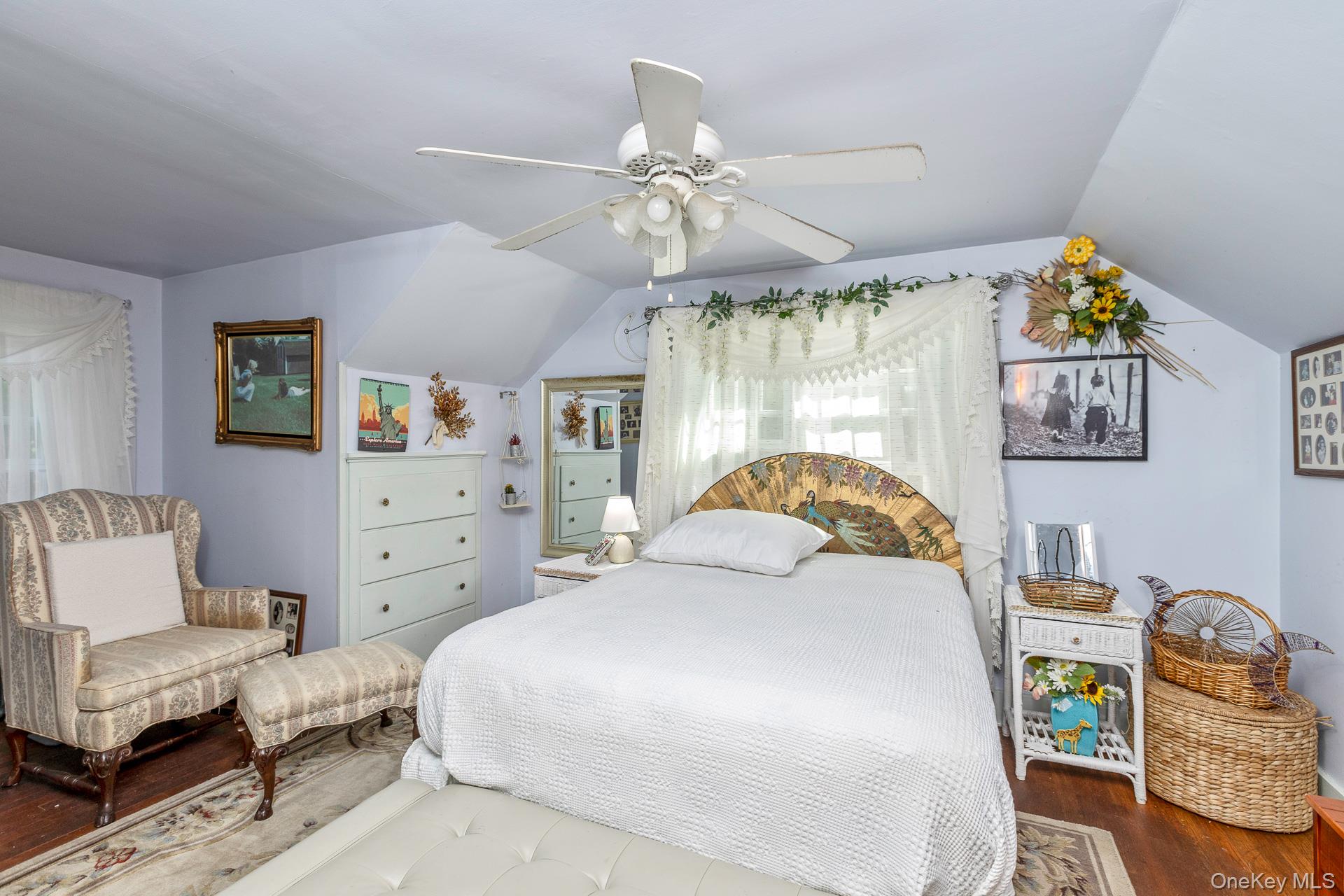 5660 Sound Avenue Mattituck, NY 11952 - Photo 25 of 43 Bedroom featuring lofted ceiling, wood finished floors, and ceiling fan