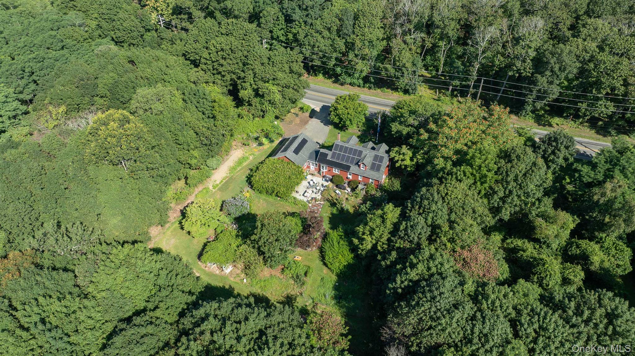 5660 Sound Avenue Mattituck, NY 11952 - Photo 3 of 43 Aerial view of property and surrounding area with a forest