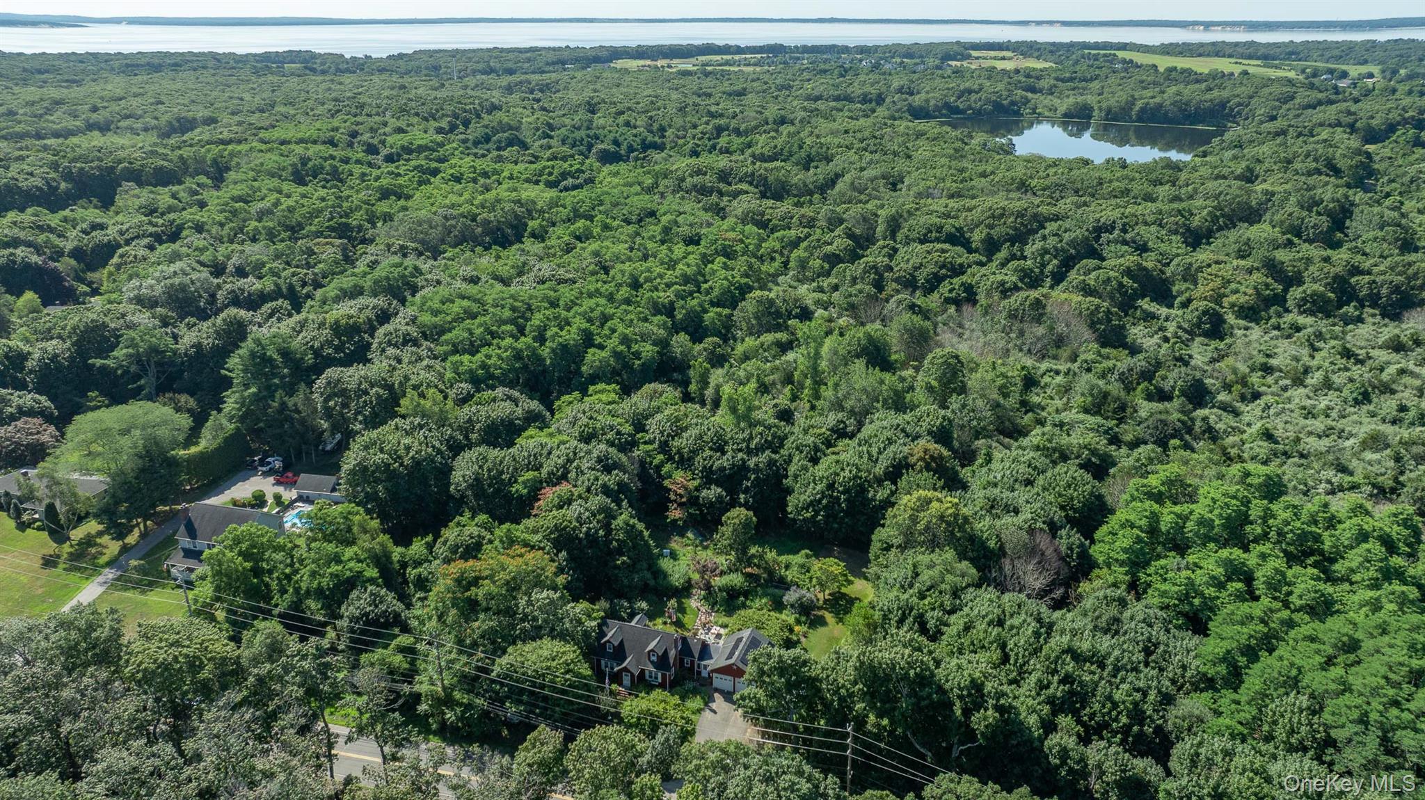 5660 Sound Avenue Mattituck, NY 11952 - Photo 40 of 43 Drone / aerial view of a nearby body of water and a forest