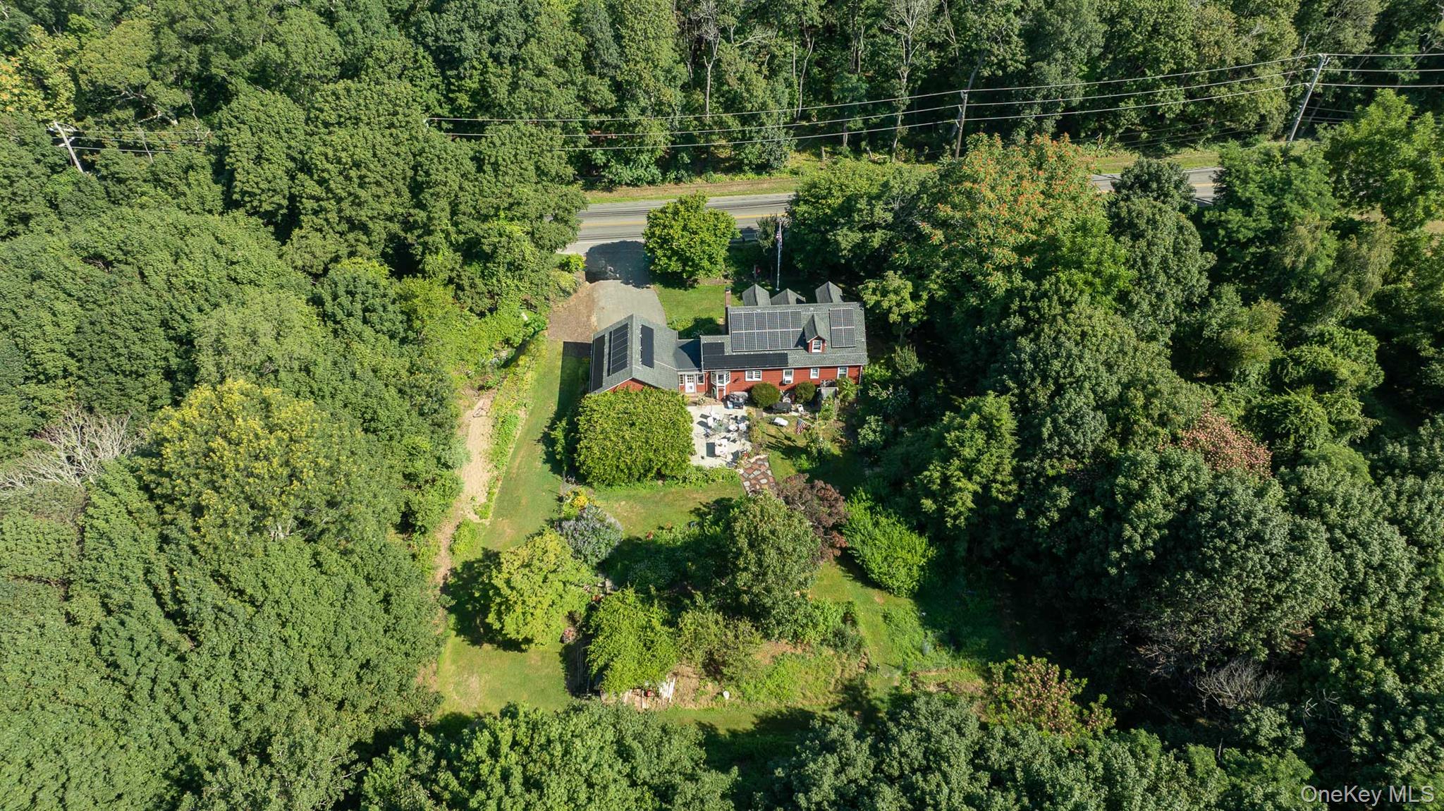 5660 Sound Avenue Mattituck, NY 11952 - Photo 43 of 43 View of subject property featuring a heavily wooded area