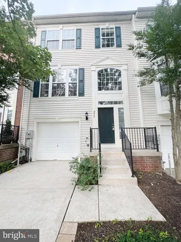 a front view of a building with a garden