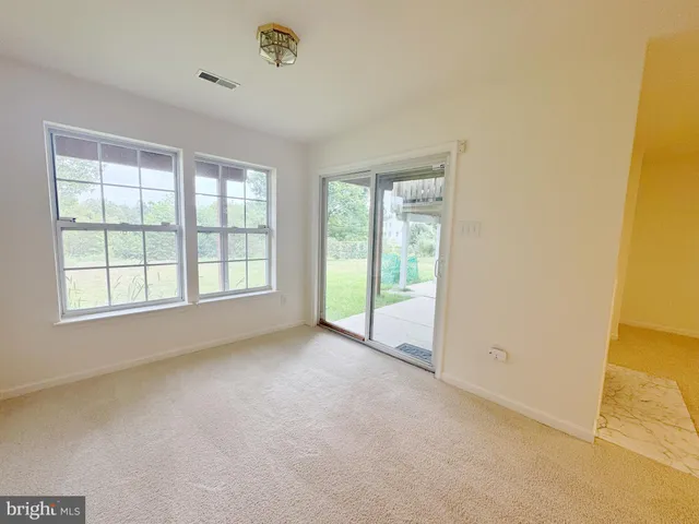 a view of a room with wooden floor and white walls