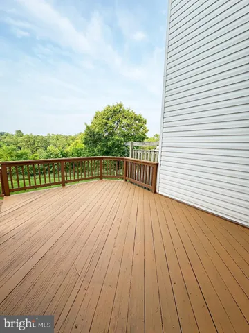 a view of a house with a yard and deck