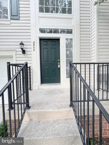 a view of a balcony with wooden floor and floor to ceiling window