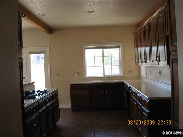 14150 Raider Run Road Reno, NV 89511 - Photo 2 of 9 a kitchen with granite countertop a stove and cabinets
