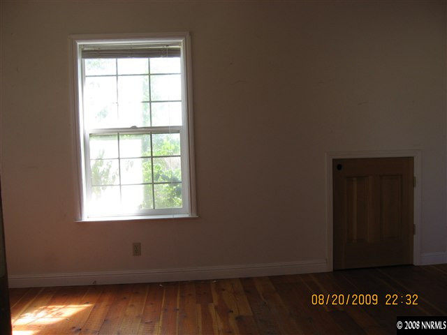 14150 Raider Run Road Reno, NV 89511 - Photo 5 of 9 an empty room with wooden floor and windows