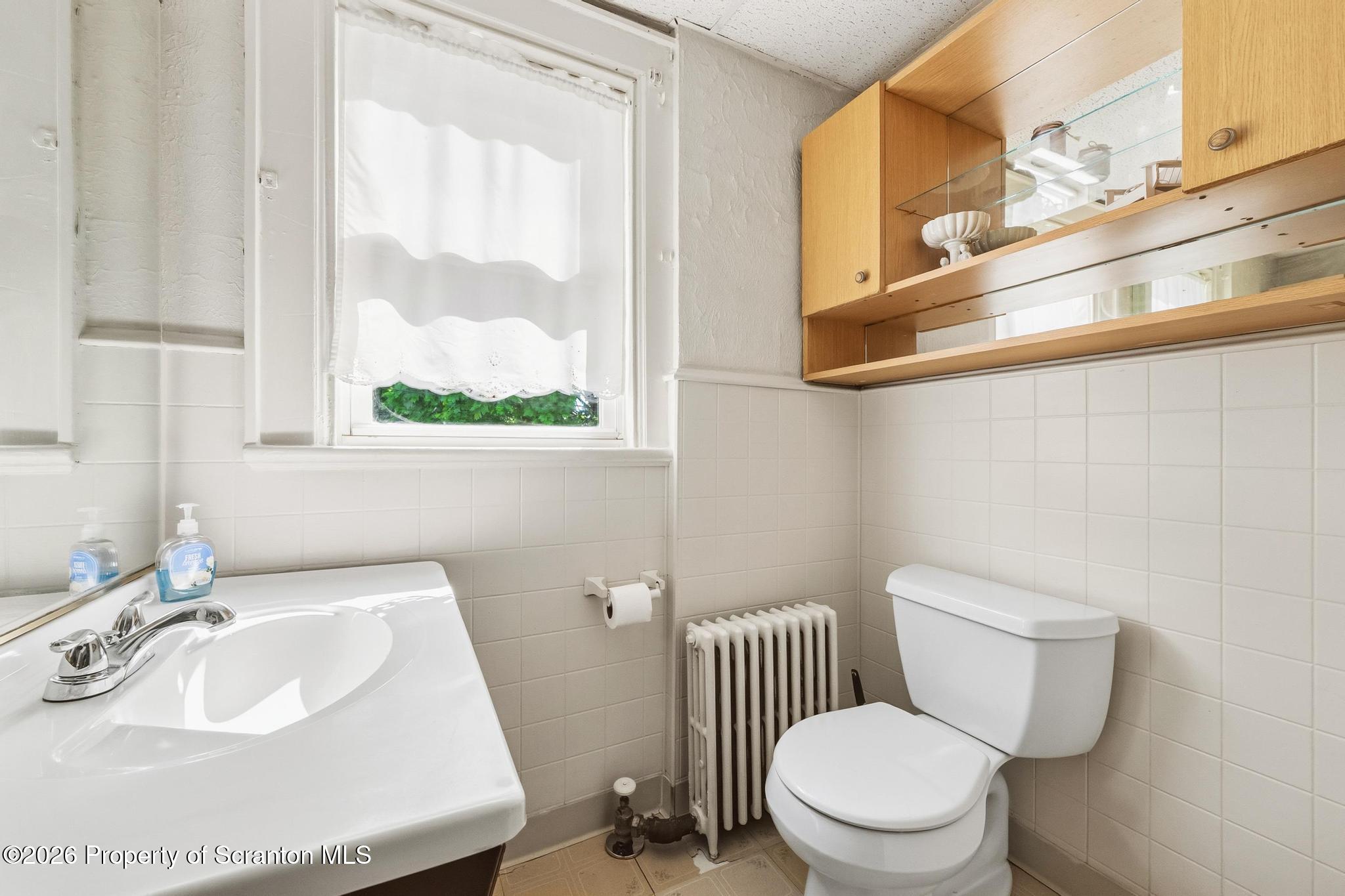 616 Myrtle Street Scranton, PA 18510 - Photo 20 of 65 a bathroom with a sink and a toilet