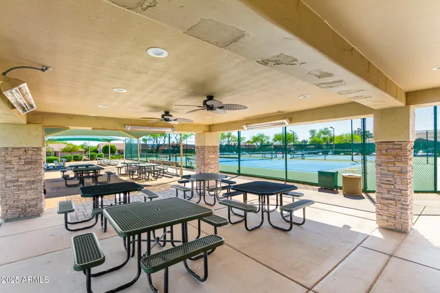 a view of a patio with a dining table and chairs
