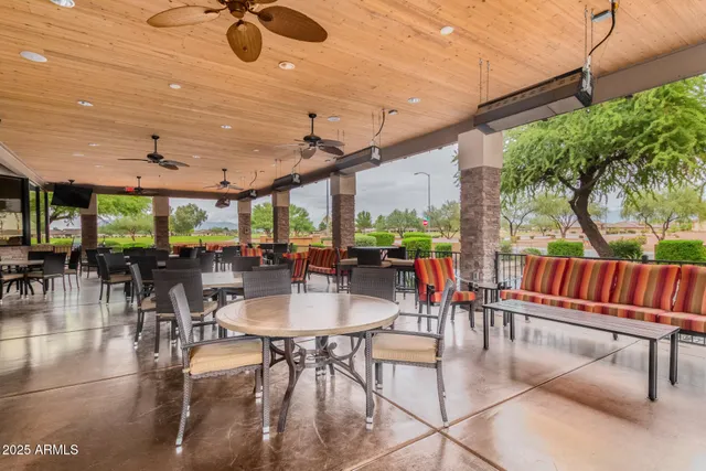 a outdoor space with lots of tables a chairs and a projector