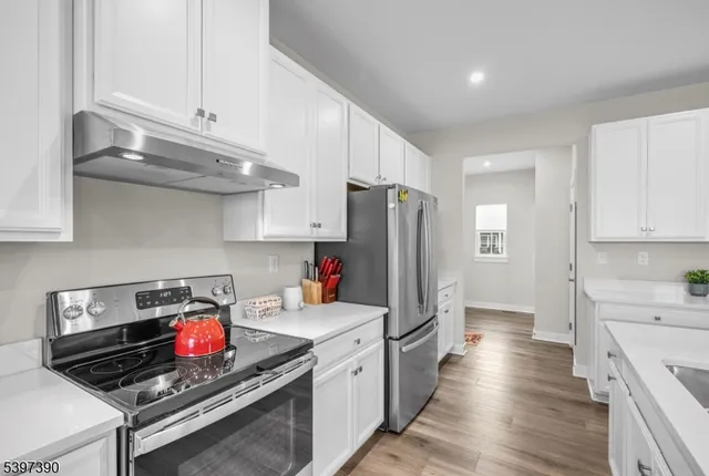 a kitchen with stainless steel appliances a stove a refrigerator and a sink