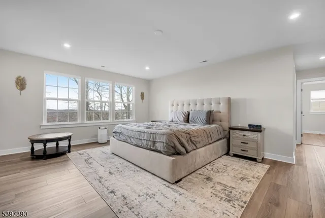 a bedroom with a large bed and a large window