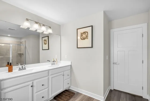 a bathroom with a double vanity sink and a mirror