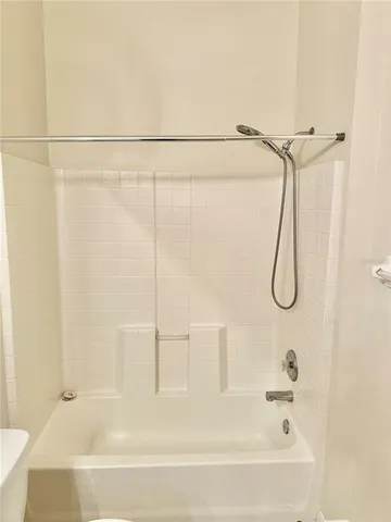 an empty room with a ceiling fan and a fan