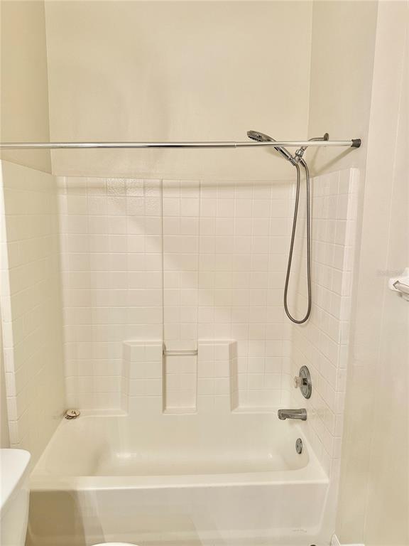 27747 Pleasure Ride Loop Wesley Chapel, FL 33544 - Photo 30 of 56 a bathroom with a bath tub with a shower