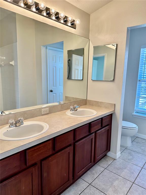 27747 Pleasure Ride Loop Wesley Chapel, FL 33544 - Photo 40 of 56 a bathroom with a granite countertop sink and a mirror