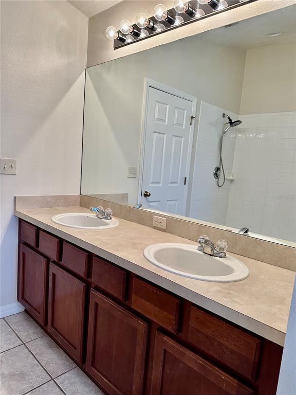 27747 Pleasure Ride Loop Wesley Chapel, FL 33544 - Photo 42 of 56 a bathroom with a sink double vanity and a mirror
