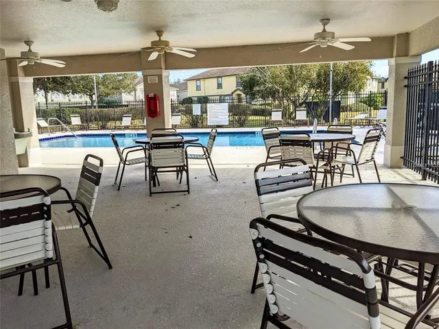 a swimming pool view with a outdoor seating