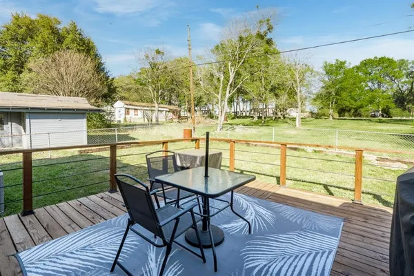 a view of a chairs and table on the wooden deck