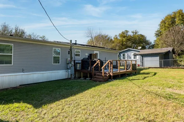 a view of a house with a yard and furniture