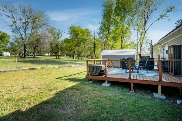 a view of a house with a yard and sitting area
