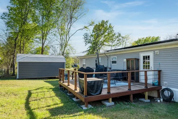 a view of a house with a yard and sitting area