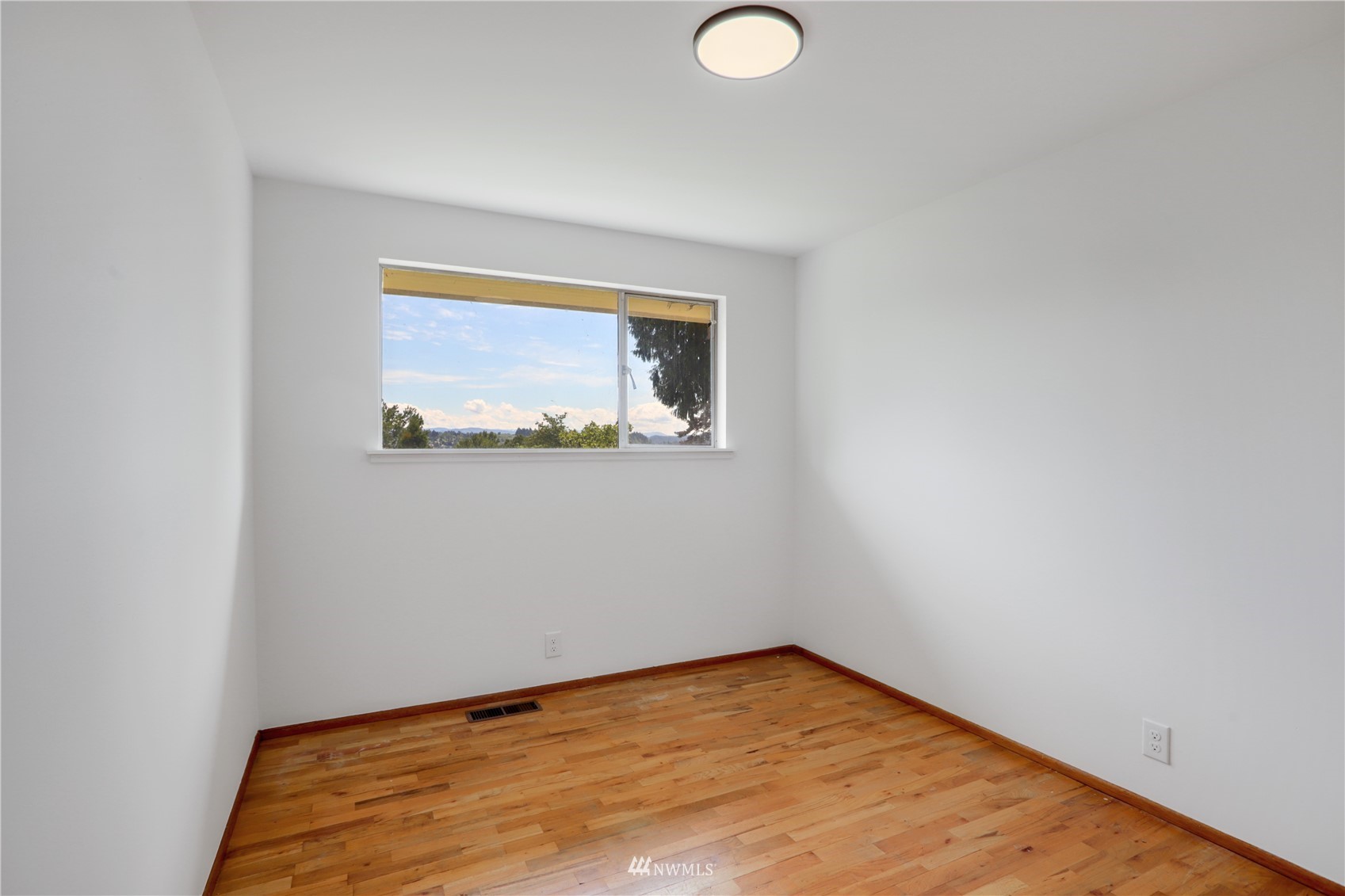 454 Lind Avenue Northwest Renton, WA 98057 - Photo 17 of 35 a view of empty room with wooden floor