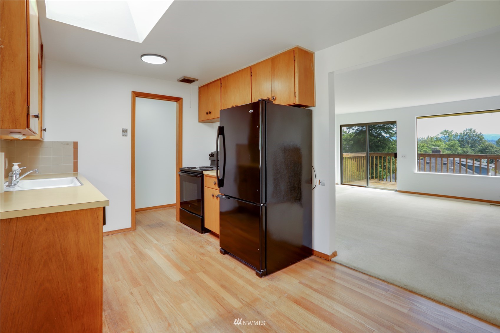 454 Lind Avenue Northwest Renton, WA 98057 - Photo 8 of 35 a kitchen with stainless steel appliances a refrigerator and a sink