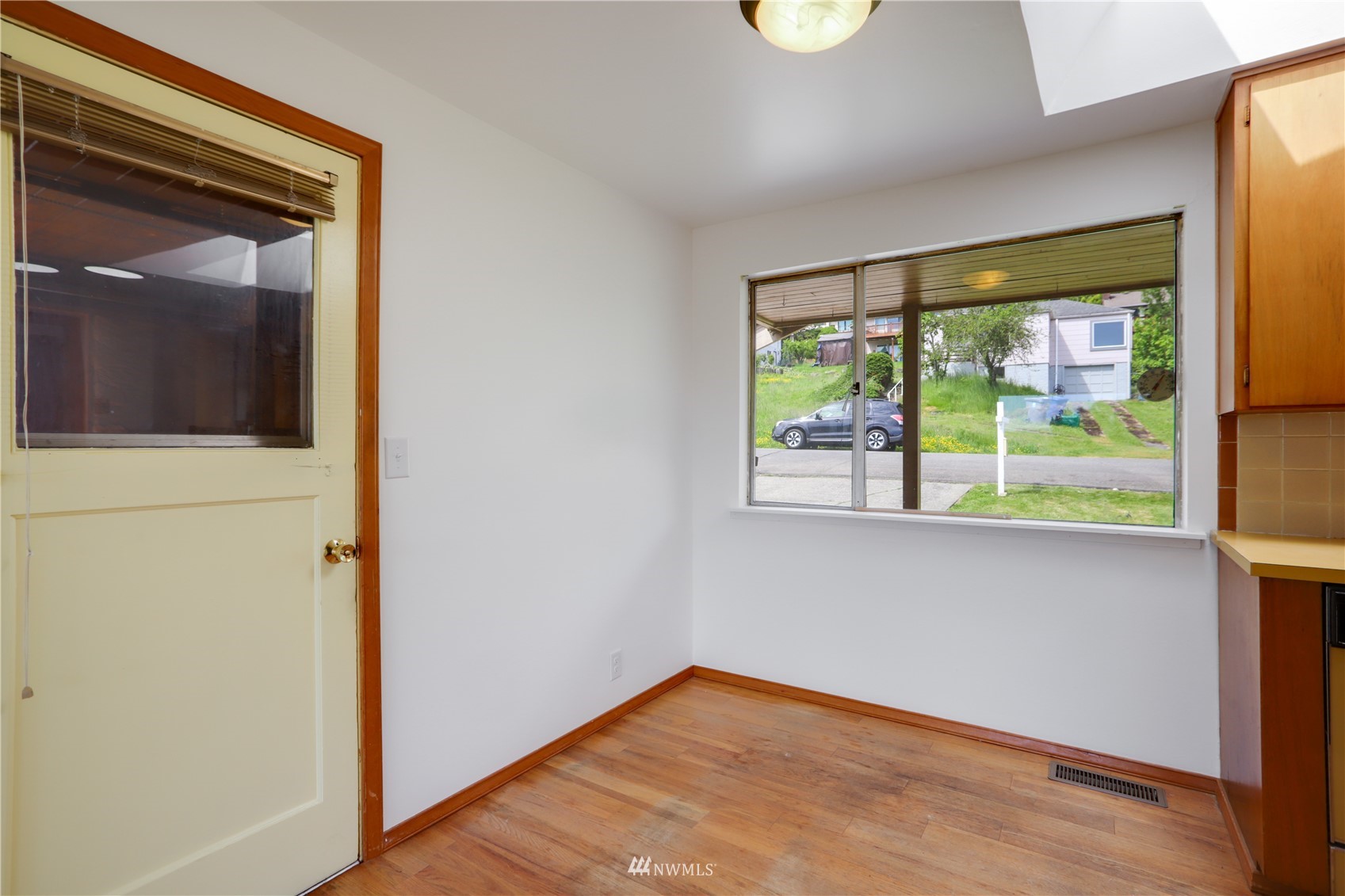 454 Lind Avenue Northwest Renton, WA 98057 - Photo 9 of 35 a view of hallway with a large window and wooden floor