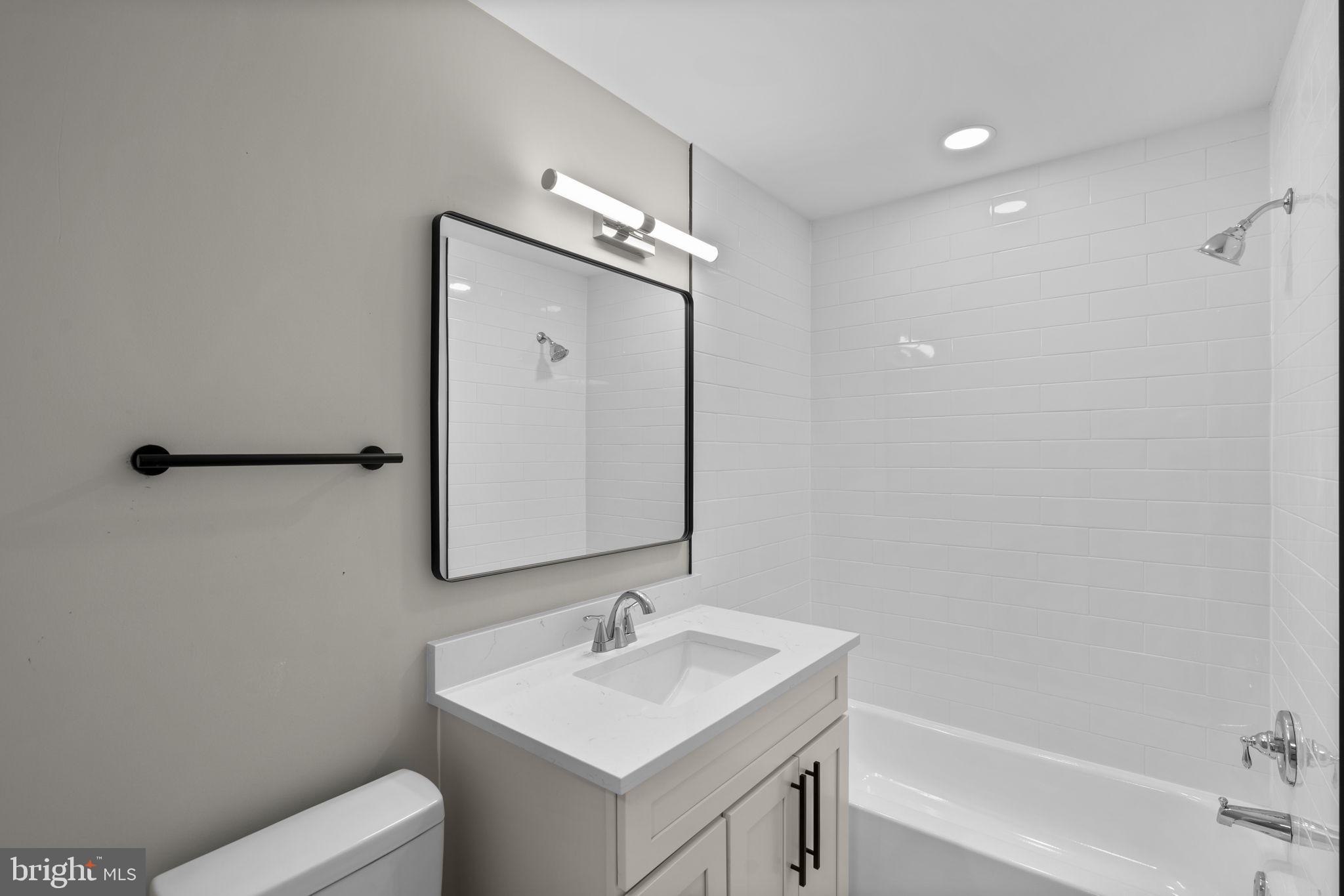 1501 Pine Grove Road Capitol Heights, MD 20743 - Photo 11 of 44 a bathroom with a toilet sink and mirror