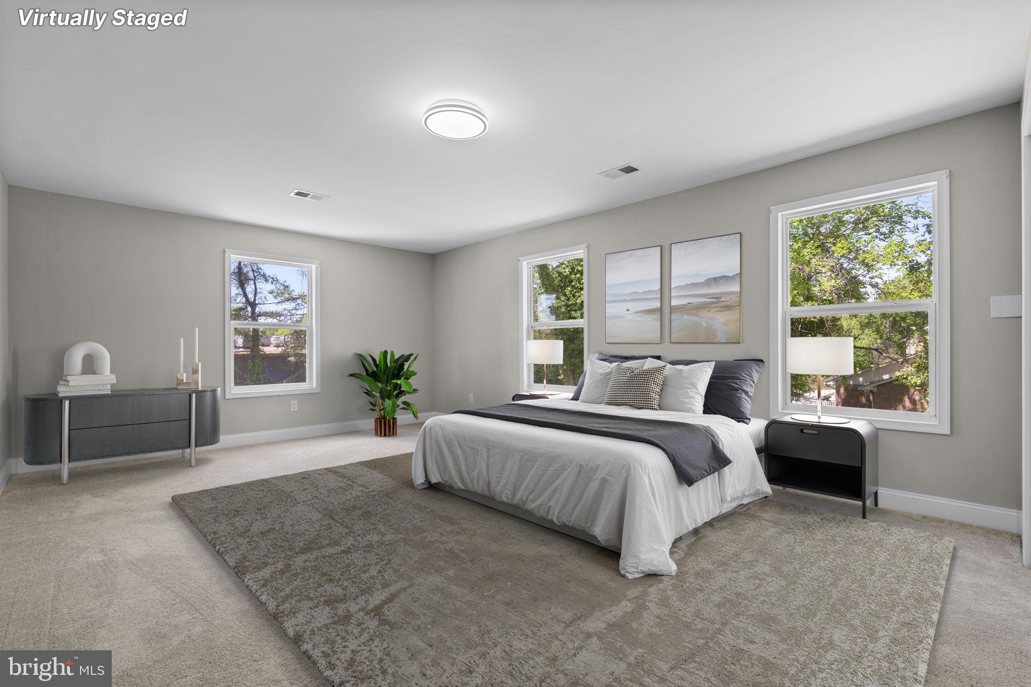 1501 Pine Grove Road Capitol Heights, MD 20743 - Photo 12 of 44 a spacious bedroom with a large bed and a large window