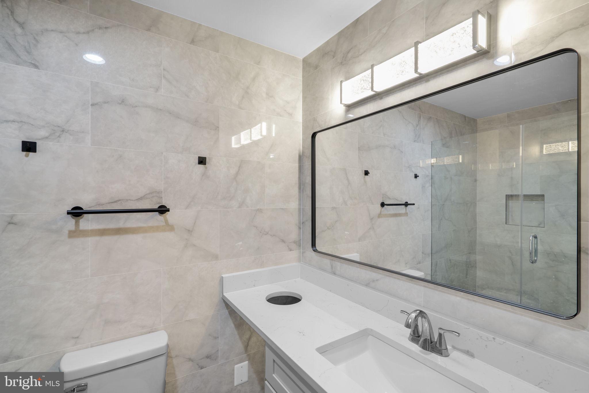 1501 Pine Grove Road Capitol Heights, MD 20743 - Photo 19 of 44 a bathroom with a sink shower and a mirror