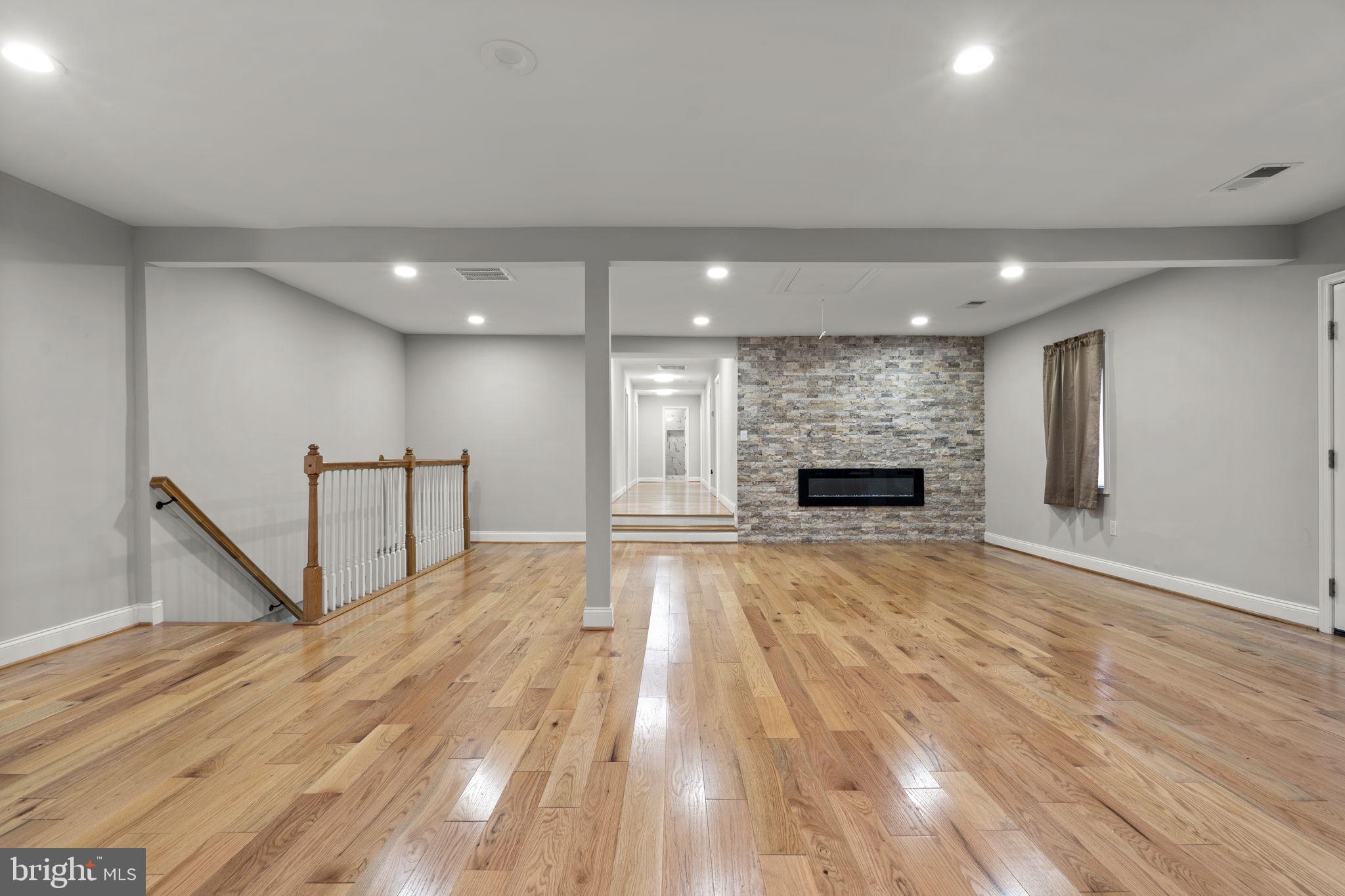 1501 Pine Grove Road Capitol Heights, MD 20743 - Photo 2 of 44 a view of an empty room with wooden floor and a fireplace