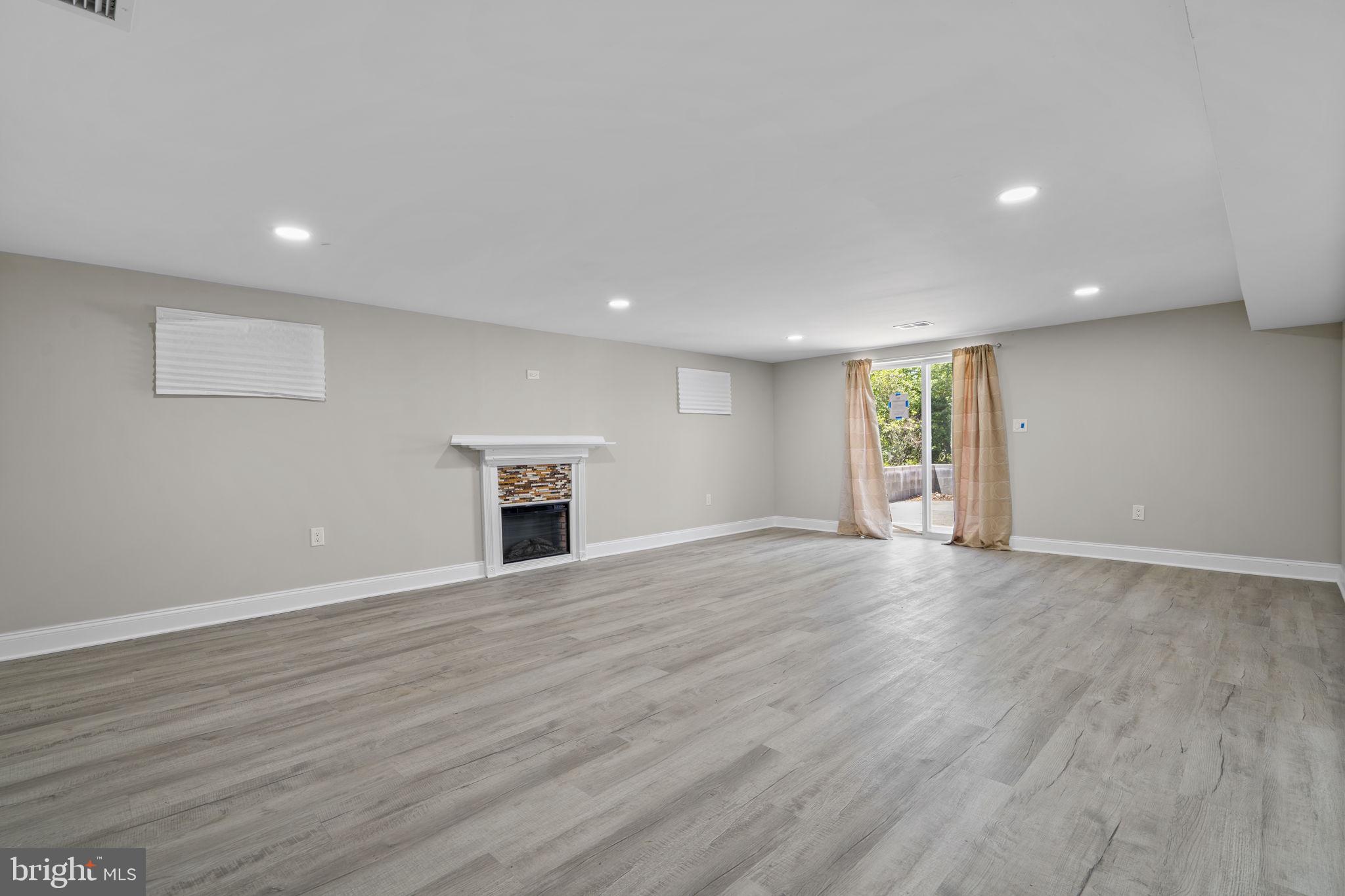 1501 Pine Grove Road Capitol Heights, MD 20743 - Photo 29 of 44 an empty room with wooden floor and windows