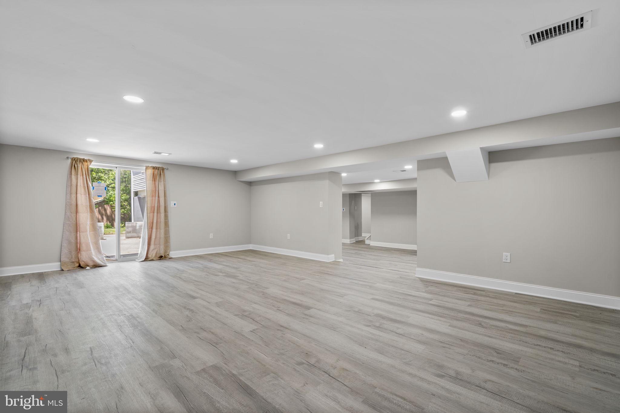 1501 Pine Grove Road Capitol Heights, MD 20743 - Photo 30 of 44 a view of an empty room with wooden floor and a window