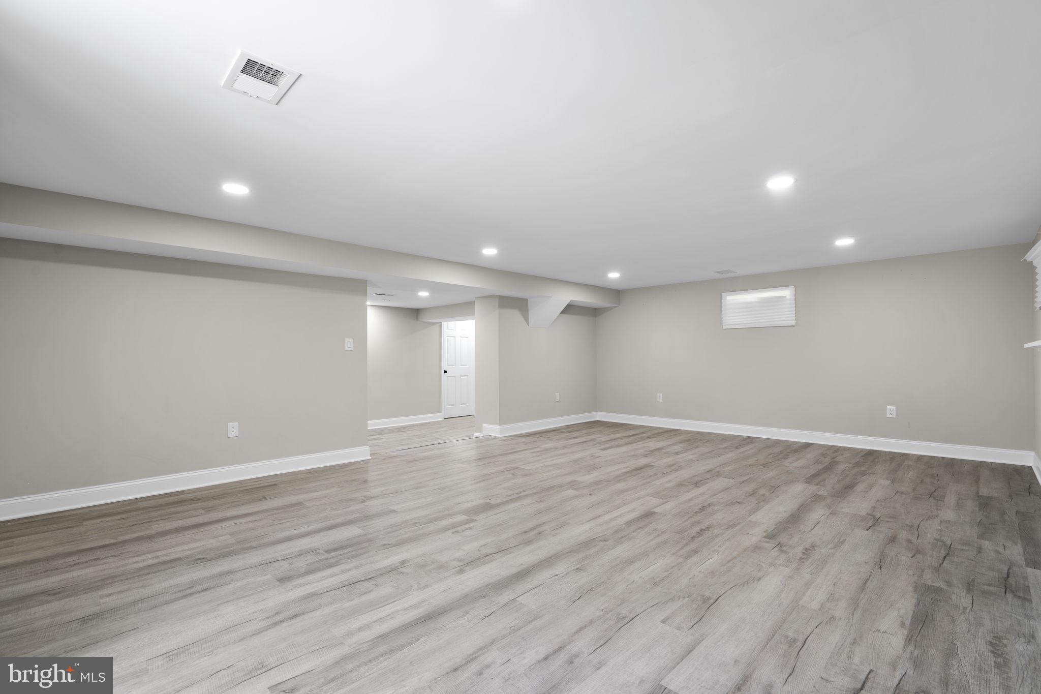 1501 Pine Grove Road Capitol Heights, MD 20743 - Photo 33 of 44 an empty room with wooden floor and windows
