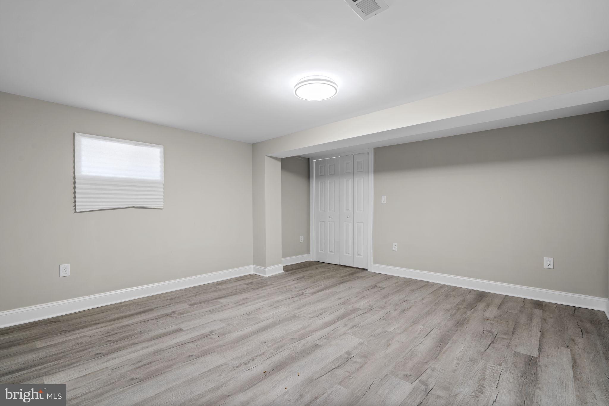 1501 Pine Grove Road Capitol Heights, MD 20743 - Photo 34 of 44 a view of an empty room with wooden floor and a window